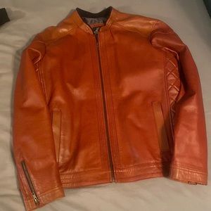 Mens leather  jacket(size L) the color is a shade of brick red. Genuine material